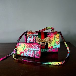 A colorful handbag with matching wallet